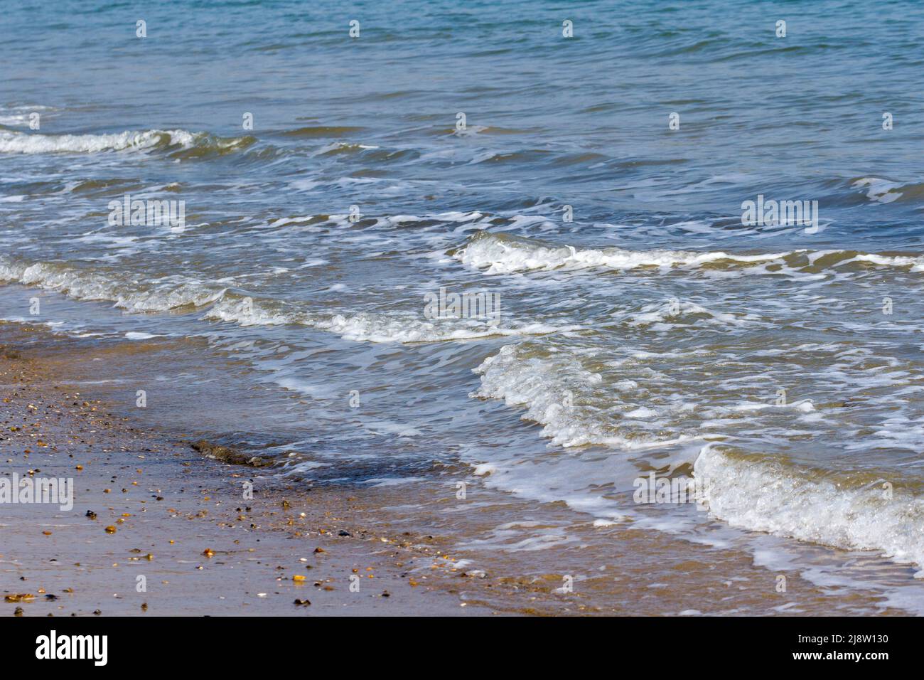 Ocean waves breaking onto a beach at Swanage, Dorset, England Stock Photo