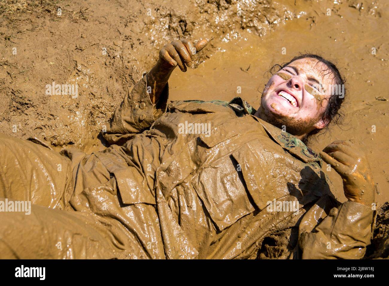 Annapolis, United States. 17th May, 2022. A U.S. Naval Academy Midshipmen squirms through the mud course during midshipmen Sea Trials, May 17, 2022 in Annapolis, Maryland. Sea Trials is modeled after the Marine Corps Crucible is a capstone event for fourth class midshipmen attending the Naval Academy . Credit: MC3 Thomas Bonaparte/U.S. Navy/Alamy Live News Stock Photo