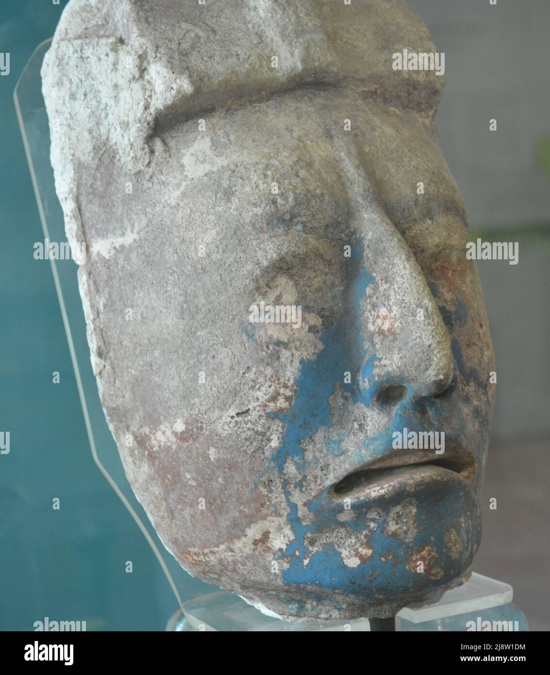 Man Face of the Maya Culture with remains of blue painting from Dzibilchaltun Archaeological Site Stock Photo