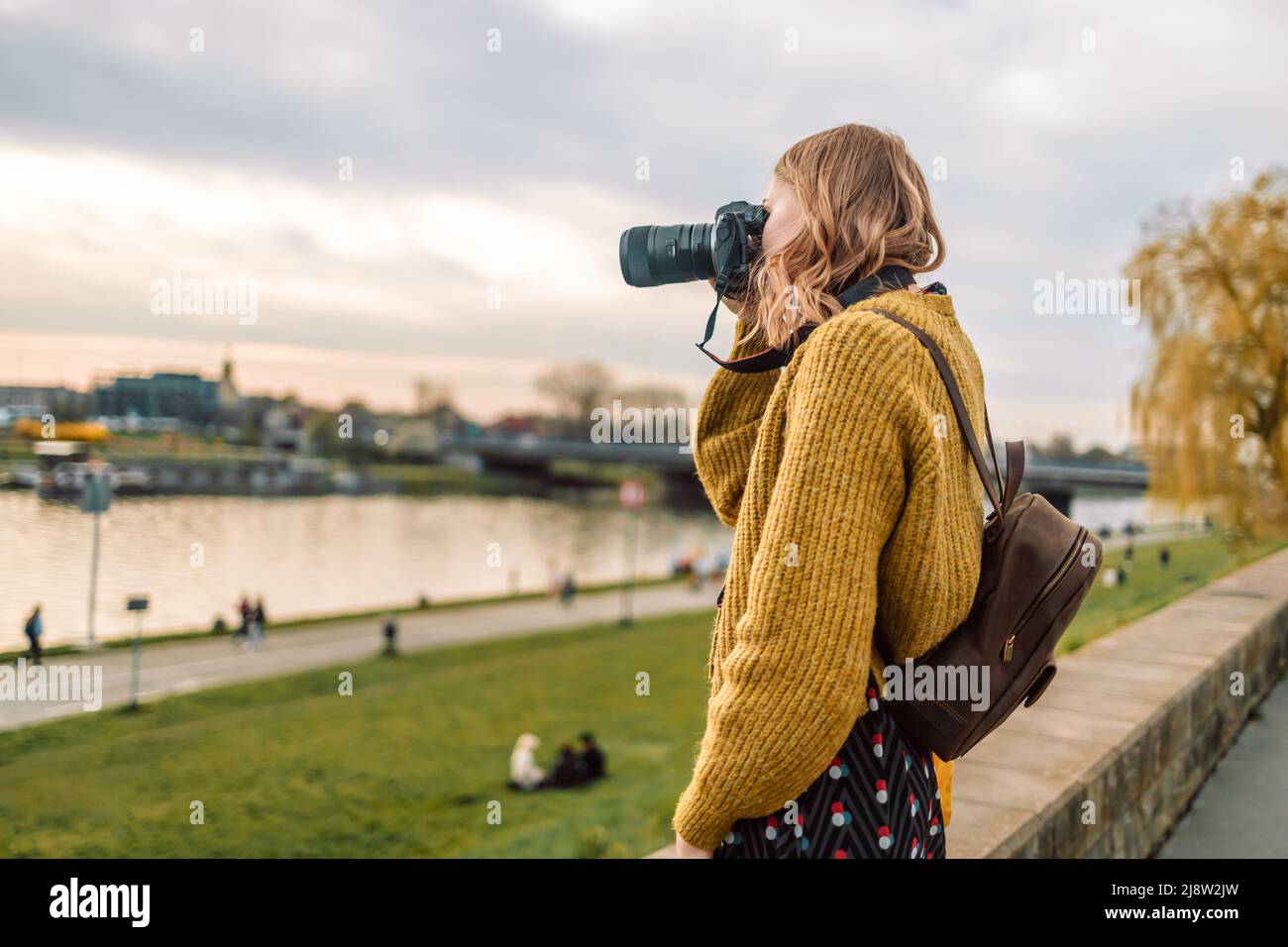 Outdoor lifestyle portrait of 30s caucasian young woman with travel . camera take photo city streets, copy space mockup Stock Photo
