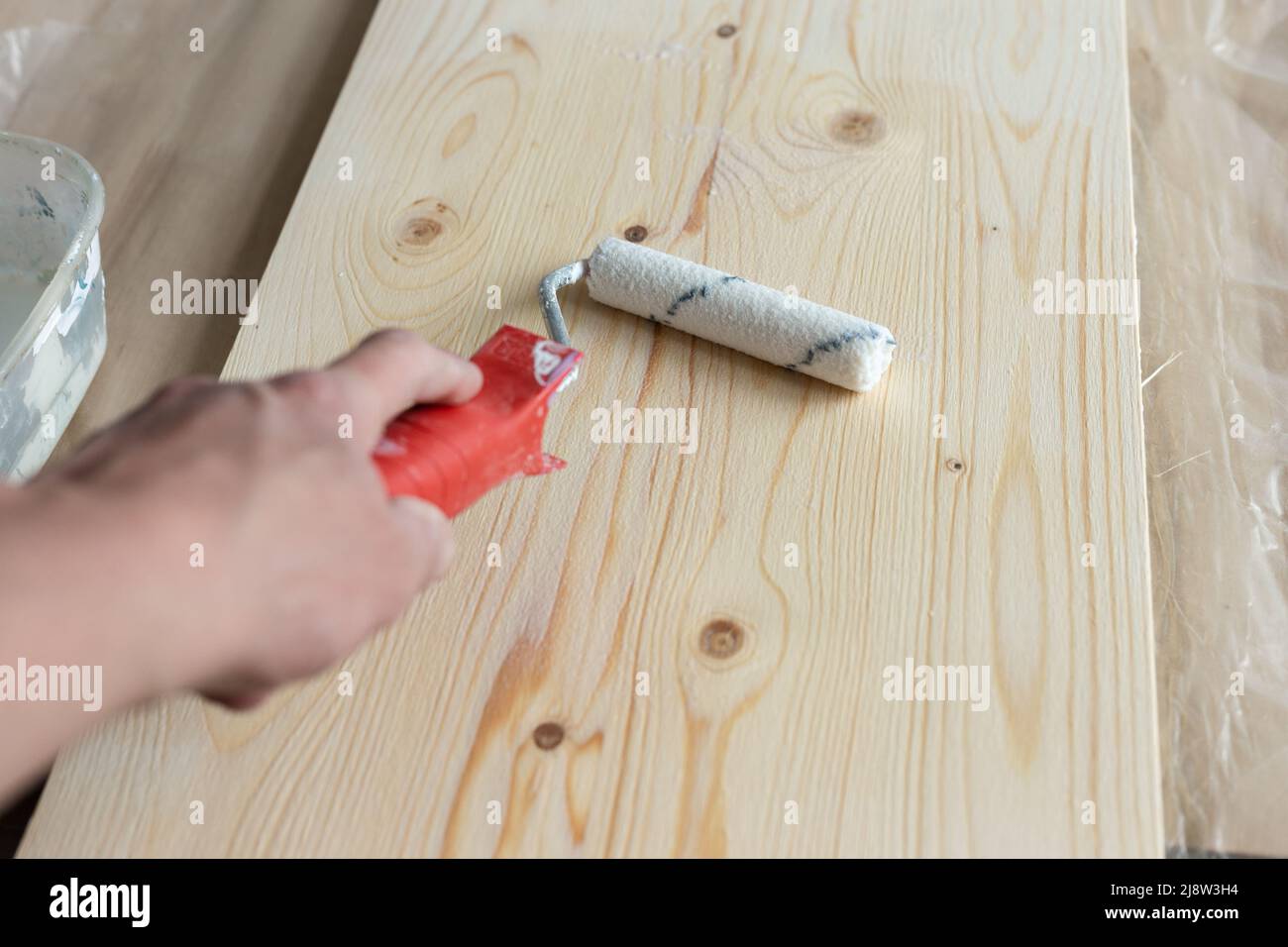 Coating the board with varnish using a roller Stock Photo Alamy