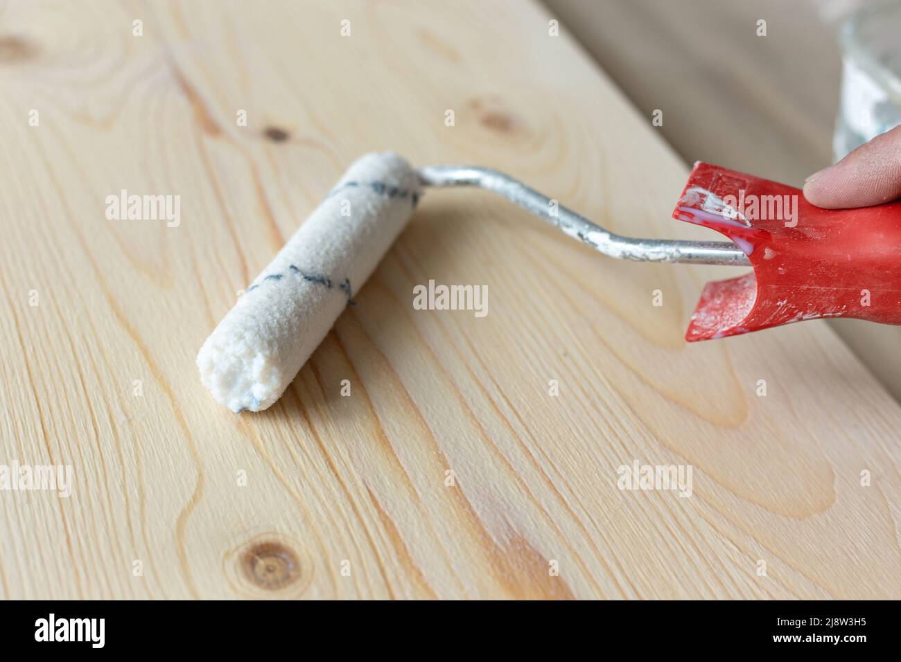 Coating the board with varnish using a roller Stock Photo Alamy