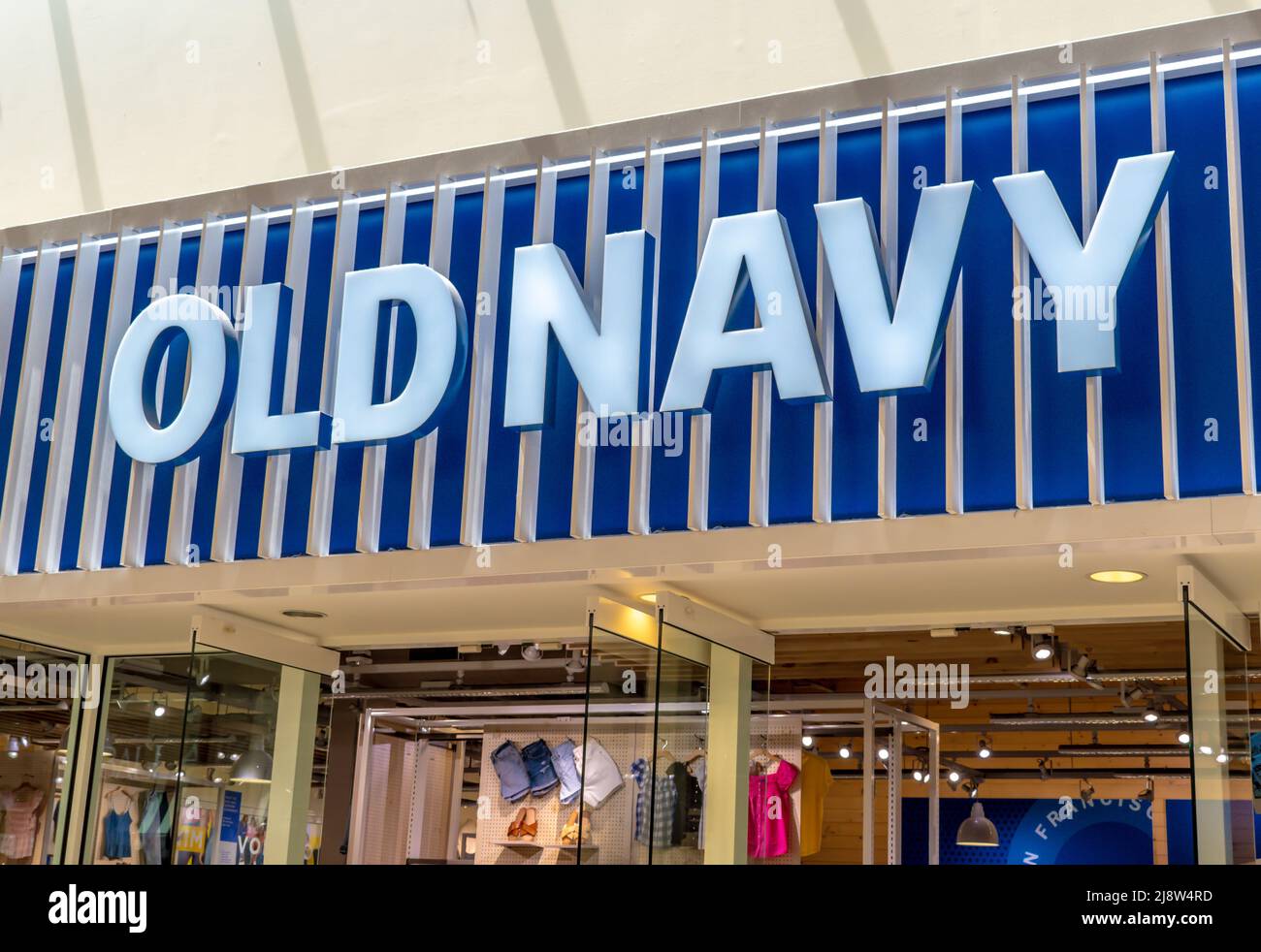 'Old Navy' indoor shopping mall facade brand and logo signage in blue and white above reflective glass windows at Southpark Mall in Charlotte, NC. Stock Photo