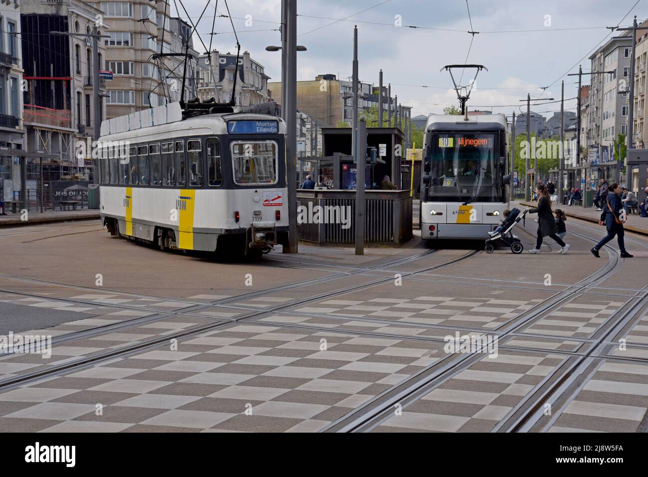 De Lijn trams at the National Bank tram stop in the centre of Antwerp, Belgium. De Lijn is the state operated transport company for Flanders - Stock Image