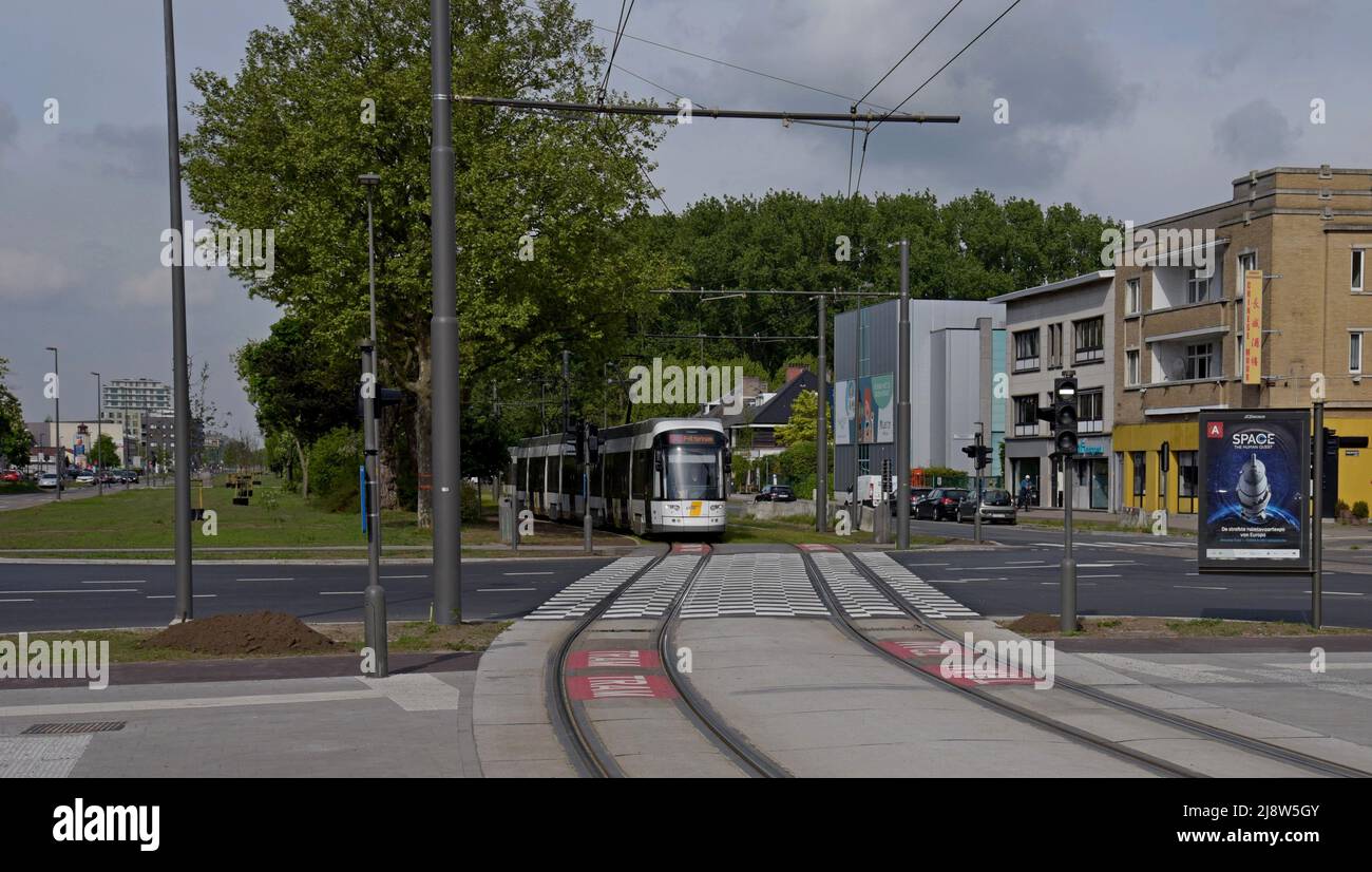 A Tram operated by DeLijn, the Flanders transport organisation, approaches Halewijn tram stop, Antwerp, Belgium - Stock Image