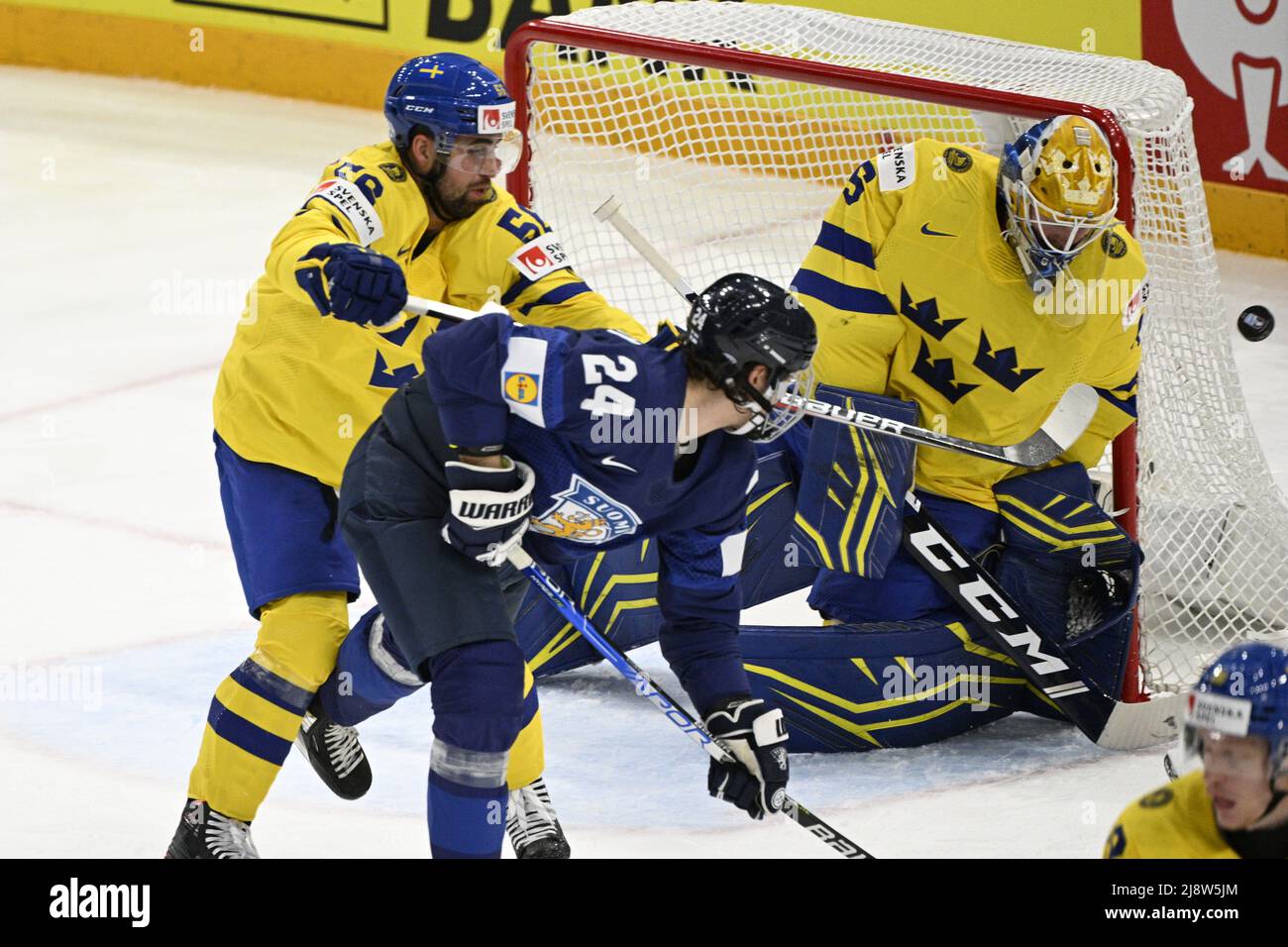 Tampere, Finland. 18th May, 2022. From left Erik Gustafsson of Sweden, Hannes Bjorninen of Finland and goalie of Sweden Magnus Hellberg in action during the Group B Ice Hockey World Championship match between Finland and Sweden in Tampere, Finland, May 18, 2022. Credit: Michal Kamaryt/CTK Photo/Alamy Live News Stock Photo