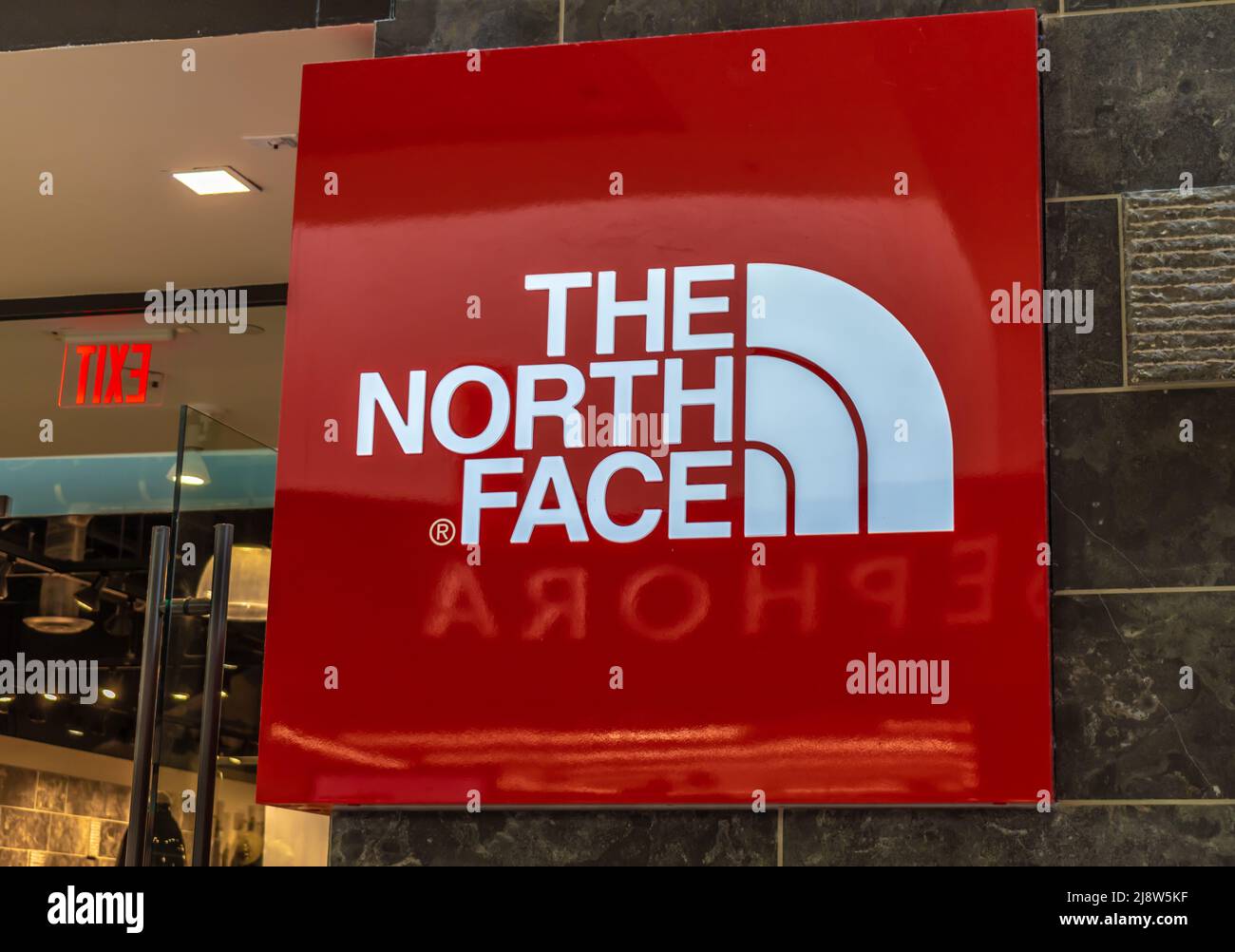 The North Face interior shopping mall brand and logo signage in red and  grey with reflections Stock Photo - Alamy