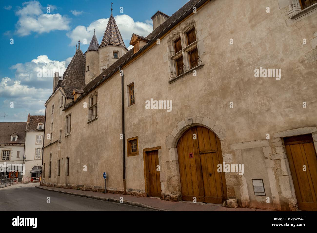 Gothic palace with large windows next to the Hotel Dieu in Beaune France Stock Photo