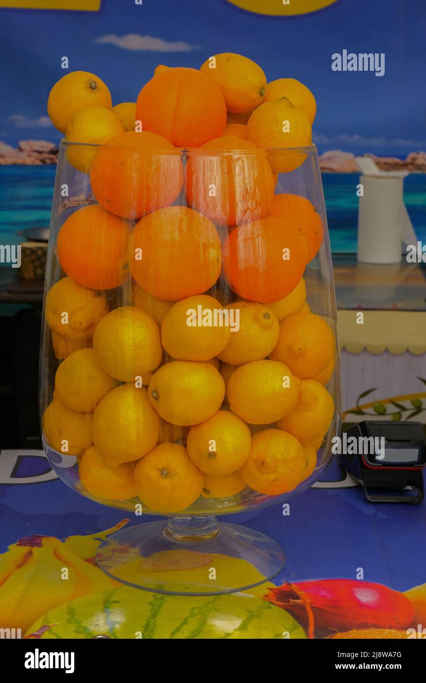 Fruit punch in a large glass bowl. Drink with a variety of fruits close