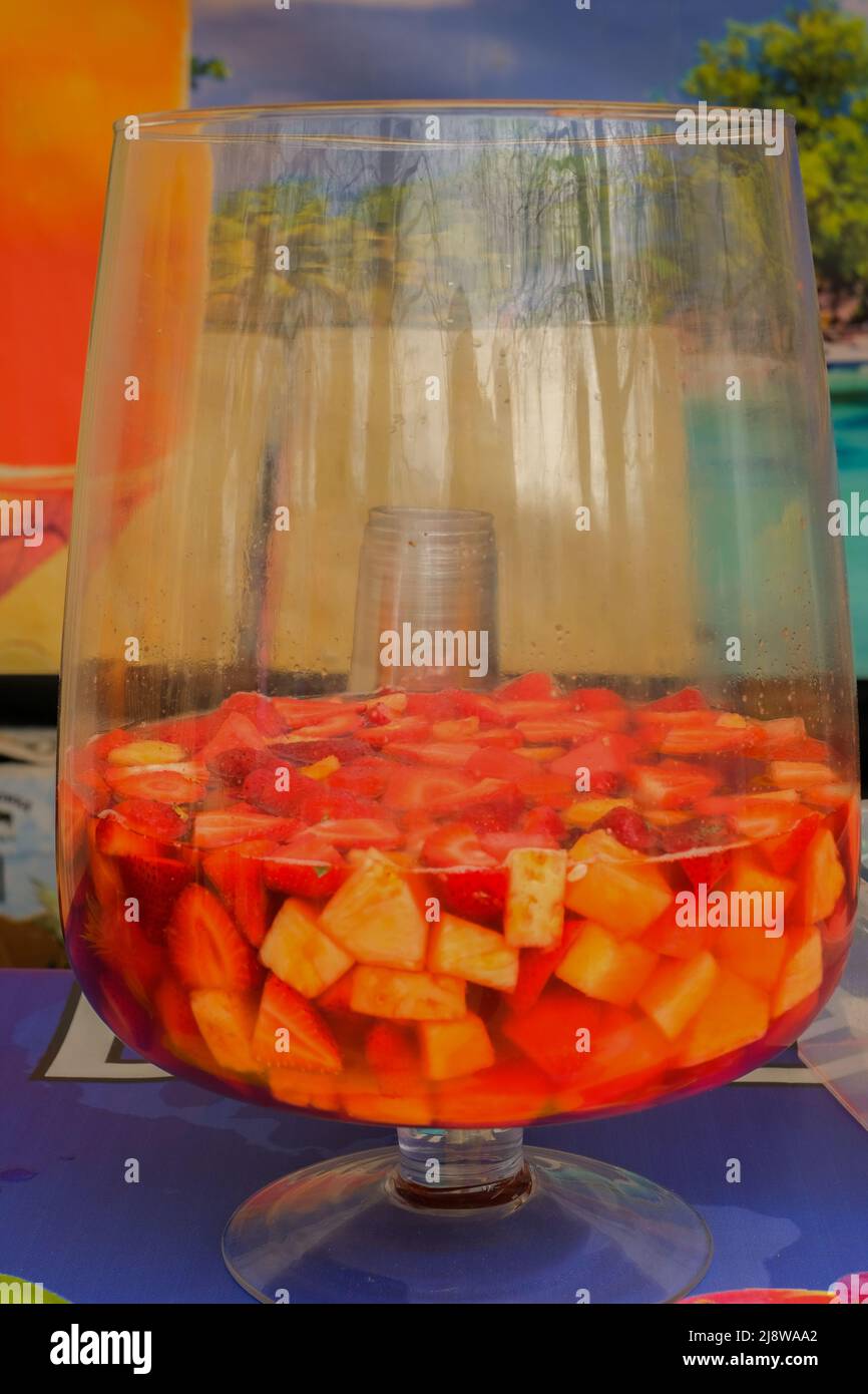 Fruit punch in a large glass bowl. Drink with a variety of fruits close