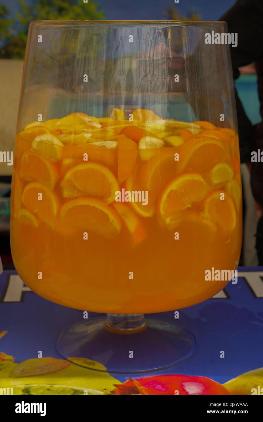 Fruit punch in a large glass bowl. Drink with a variety of fruits close