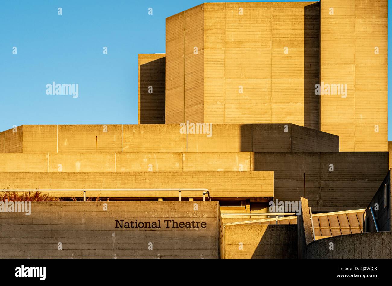 The sunlit Brutalist façade of The National Theatre, London. Stock Photo