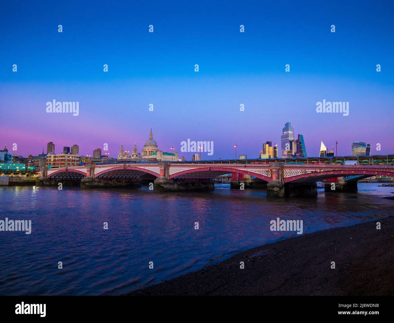 Blackfriars bridge with St Paul's Cathedral in the distance shot at magic hour from the South Bank. London UK. Stock Photo