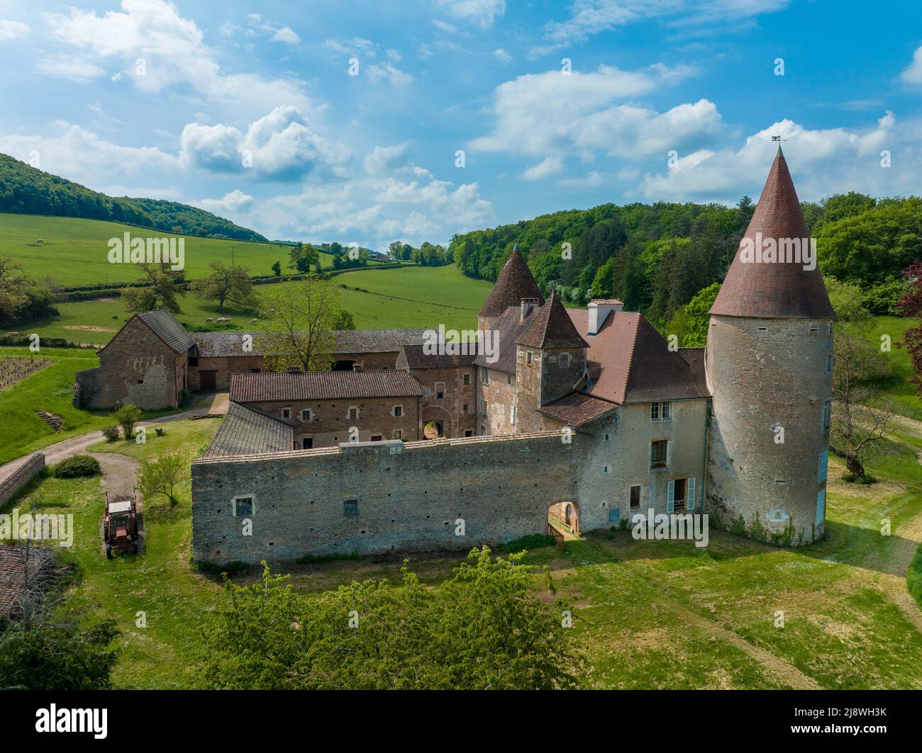 A visitor walking through the tunnel entrance to Chateau de Brancion &  historic village in Saone et Loire, Burgundy, France Stock Photo - Alamy