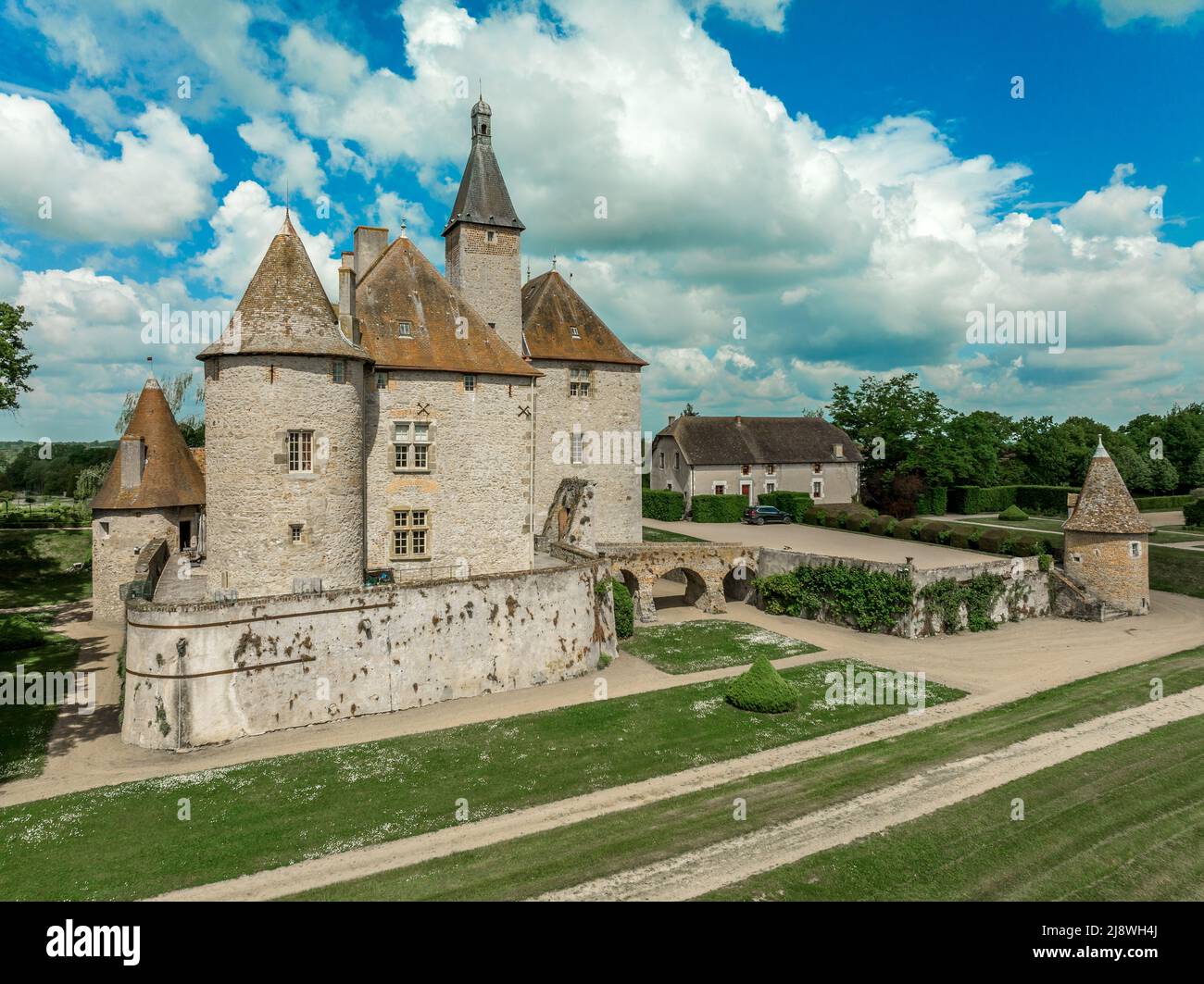 Aerial view of Chateau de Beauvoir restored medieval French castle with bridge, towers, manicured lawn and garden Stock Photo