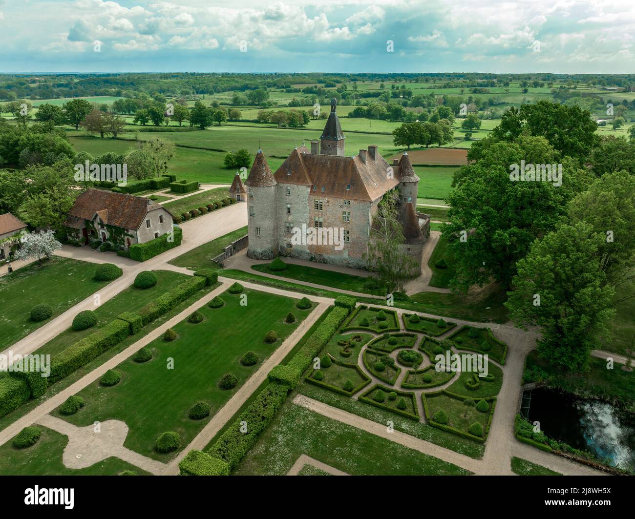 Aerial view of Chateau de Beauvoir restored medieval French castle with bridge, towers, manicured lawn and garden Stock Photo