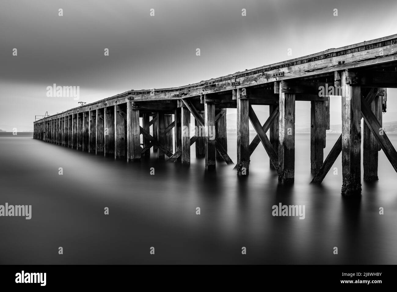 Long Exposure Monochrome Image of Lamonts Pier in Newark, Port Glasgow, Scotland which is historic and rotting. Stock Photo
