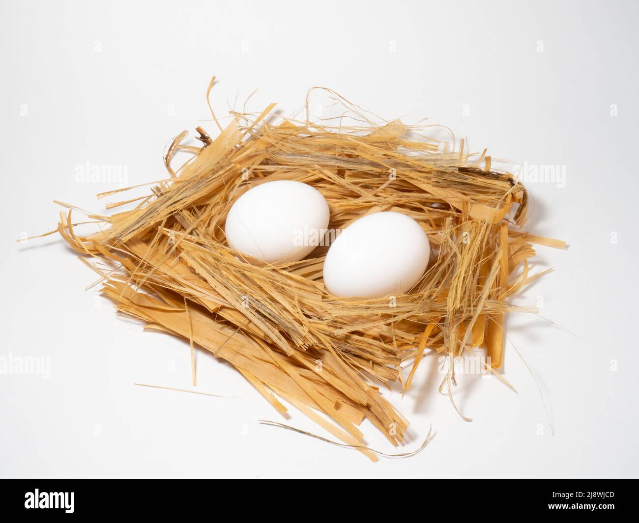 Chicken egg lies in straw Stock Photo - Alamy