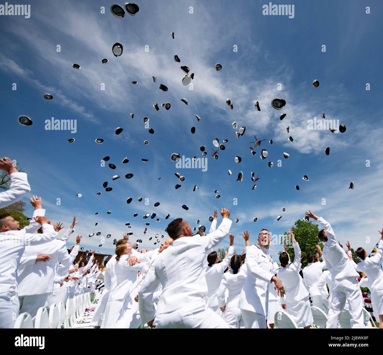 New London, United States of America. 18 May, 2022. U.S. Coast Guard Academy graduates toss their hats into the air to celebrate the conclusion of the 141st Commencement Ceremony at the Coast Guard Academy, May 18, 2022 in New London, Connecticut. The Coast Guard Academy graduated 252 new officers along with nine international students. Credit: PO3 Matthew Thieme/U.S. Coast Guard Photo/Alamy Live News Stock Photo