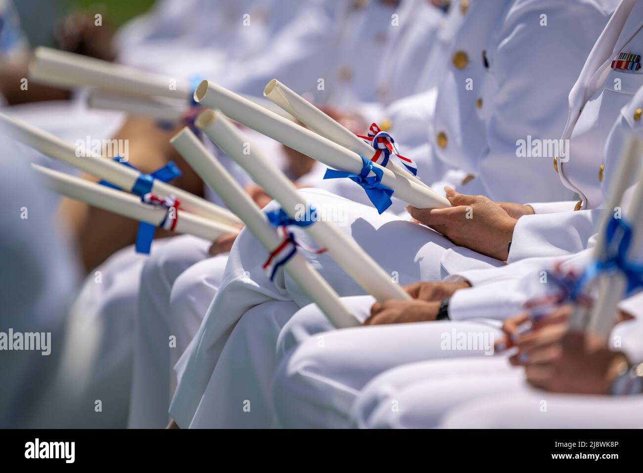 New London, United States of America. 18 May, 2022. U.S. Coast Guard Academy cadets hold their diplomas during the 141st Commencement Ceremony at the Coast Guard Academy, May 18, 2022 in New London, Connecticut. The Coast Guard Academy graduated 252 new officers along with nine international students. Credit: David Lau/U.S. Coast Guard Photo/Alamy Live News Stock Photo