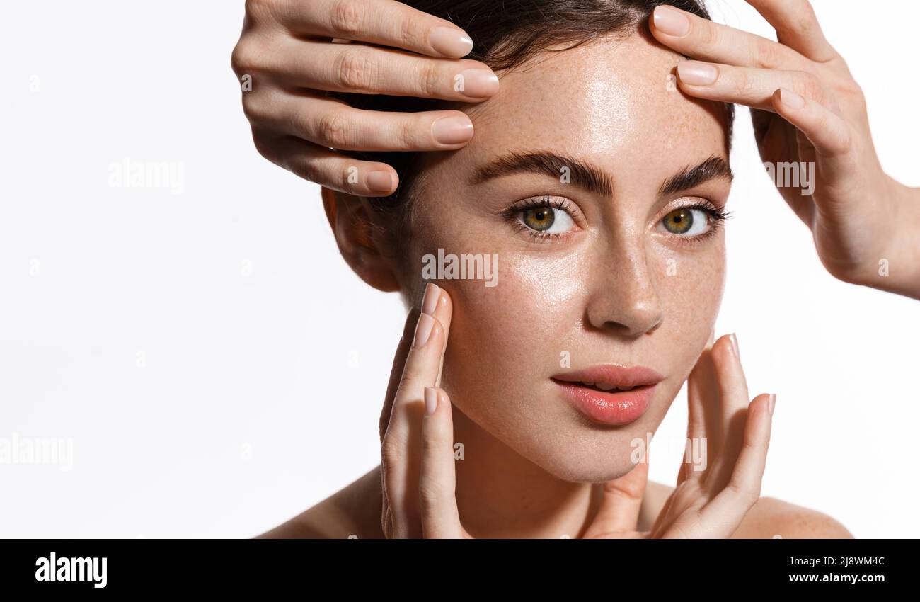 Hands massaging and touching woman face. Spa and facial massage concept