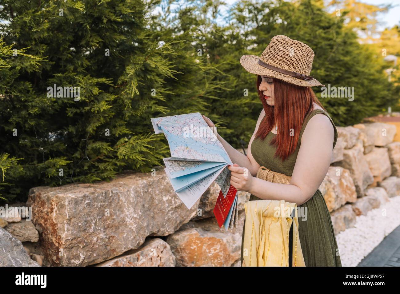 young girl travelling, lost, looking for directions to her holiday destination on a map. tourist asking for directions. Stock Photo