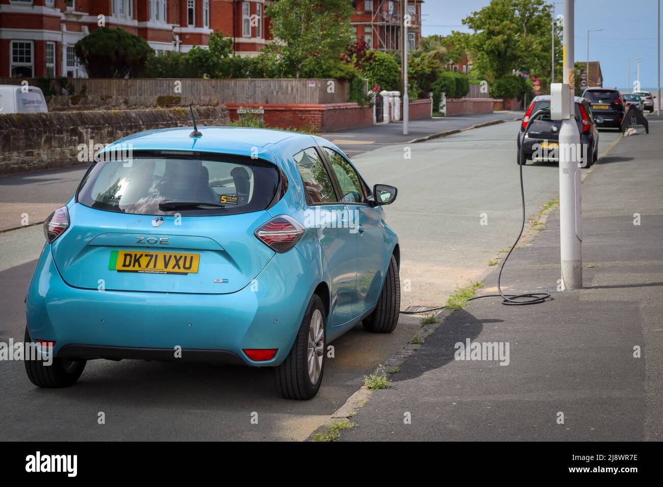 Electric car on charge from a lamppost charging point Stock Photo