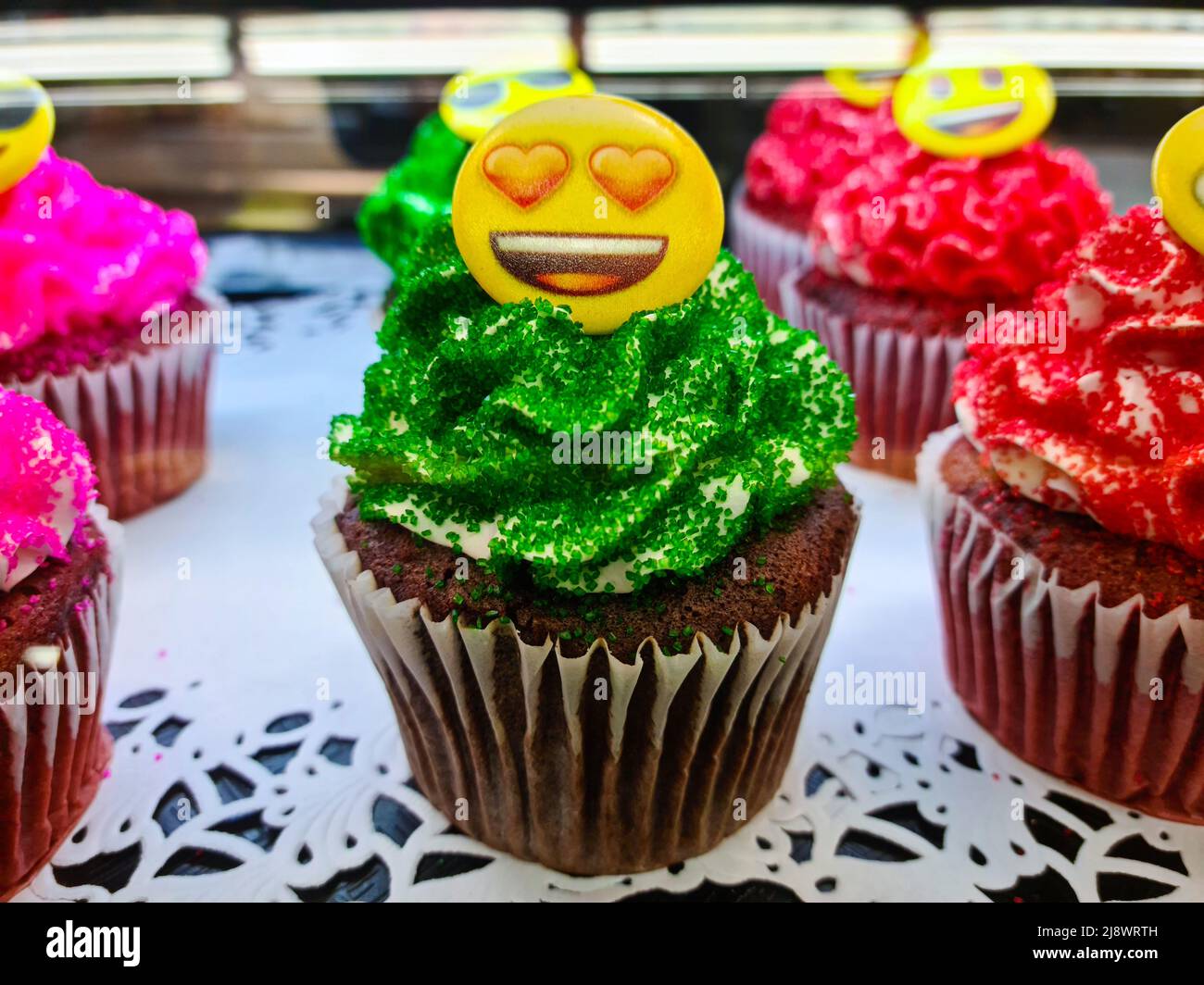 confectionery showcase with cupcake assorted flavors Stock Photo Alamy
