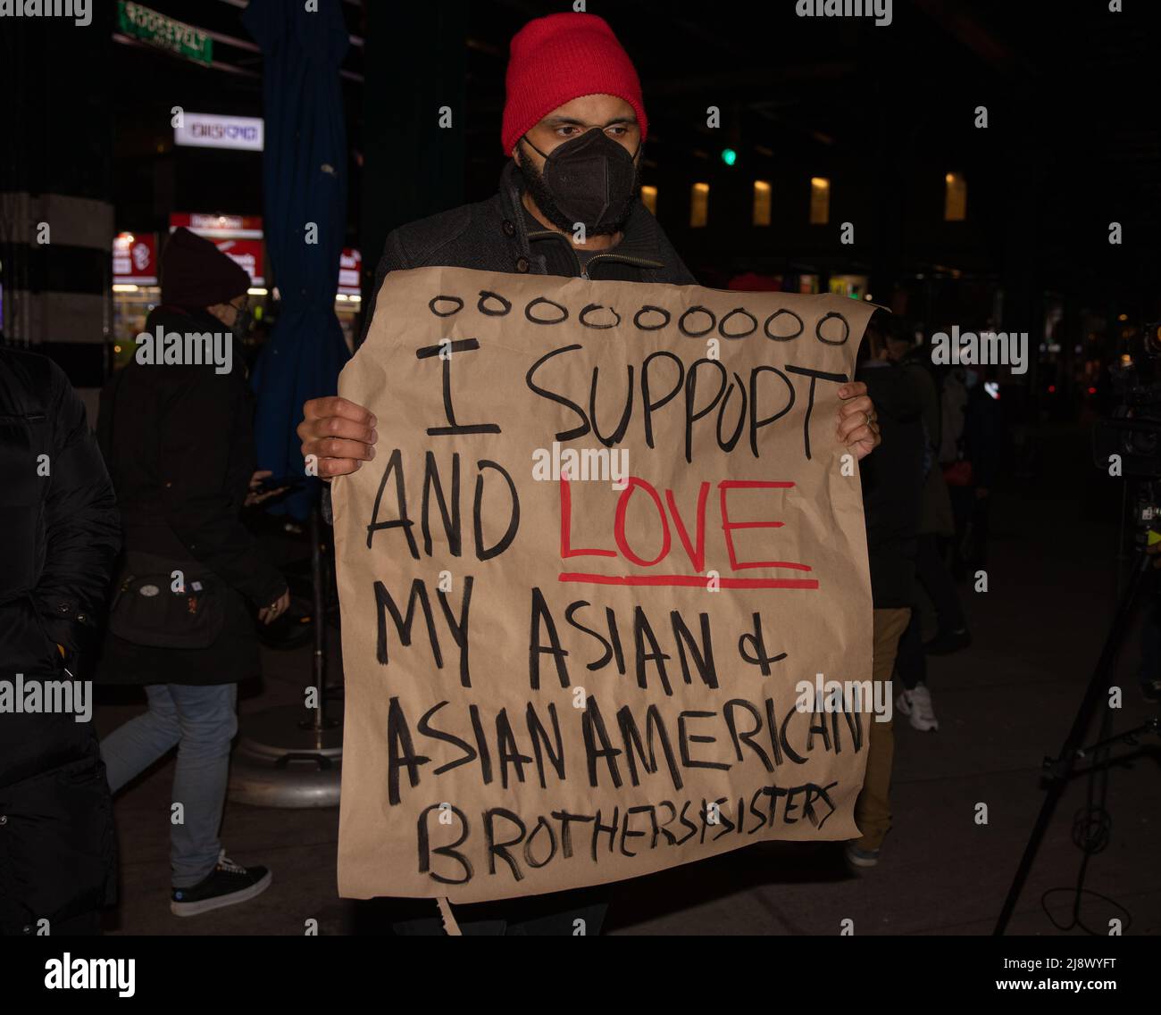 QUEENS, N.Y. – March 17, 2021: A demonstrator is seen in Jackson Heights during a vigil for victims of anti-Asian violence. Stock Photo