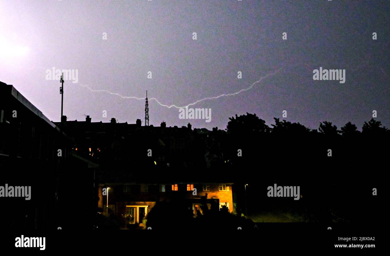 Brighton UK 19th May 2022 - Lightning lights up the skies over  the Whitehawk transmitter in Brighton tonight as storms sweep across the South East of England   : Credit Simon Dack / Alamy Live News Stock Photo