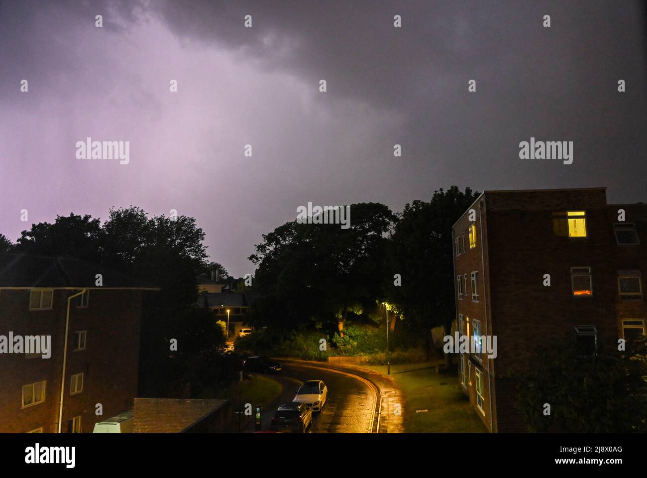 Brighton UK 19th May 2022 - Sheet lightning lights up the skies over  the Queens Park area of Brighton tonight as storms sweep across the South East of England   : Credit Simon Dack / Alamy Live News Stock Photo