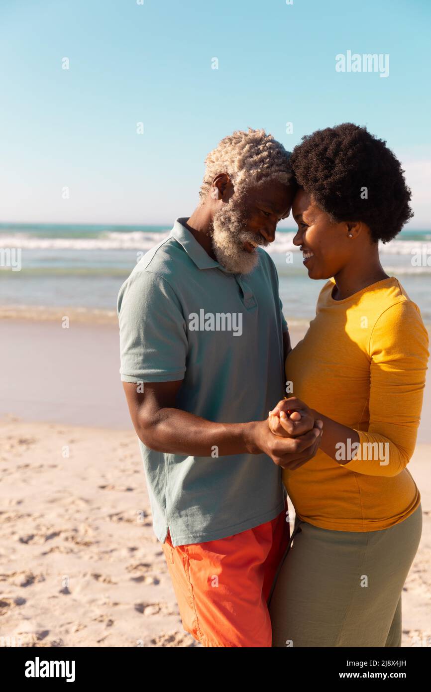 Romantic african american couple looking at each other while dancing ...
