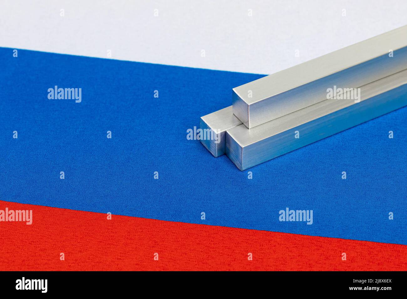 Aluminum metal stock on Russia flag. Russian aluminum exports, trade and industry concept. Stock Photo