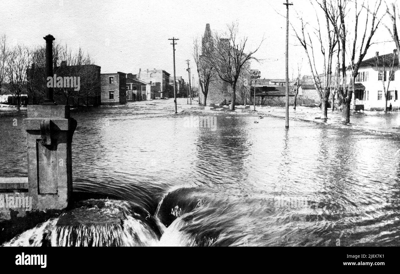 1918 Flood - Looking north on Front Street at Dundas Street, Belleville, Ontario. On the right is the early Simpson's Inn / Wallbridge Home  ca.  1918 Stock Photo