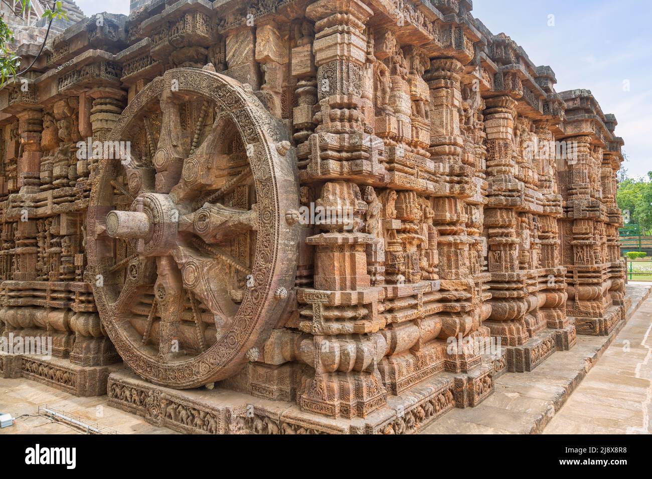 Large stone wheel with ancient carvings on the walls of Konark Sun temple at Puri Odisha, India Stock Photo