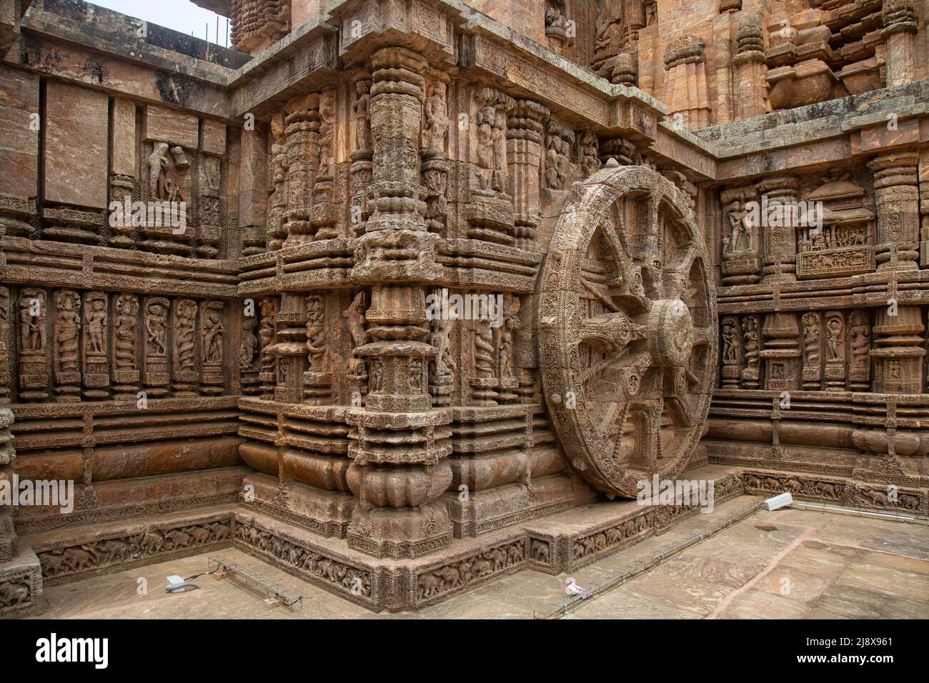 Large stone wheel with ancient carvings on the walls of Konark Sun temple at Puri Odisha, India Stock Photo