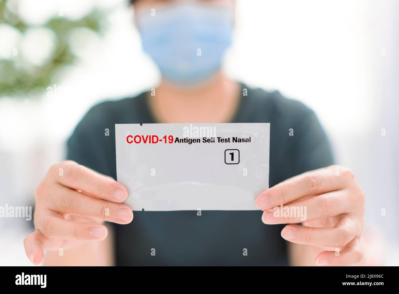 Woman showing  COVID-19 home self test kit Stock Photo