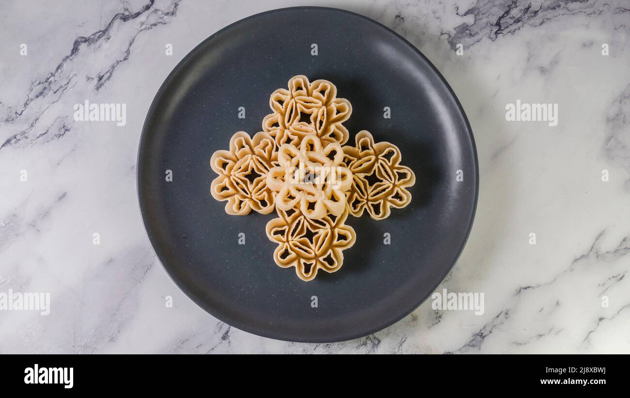 Malaysian Kuih Raya called Kuih Goyang or Kuih Ros. Popular traditional kuih raya on Hari Raya Aidilfitri in Malaysia. Stock Photo