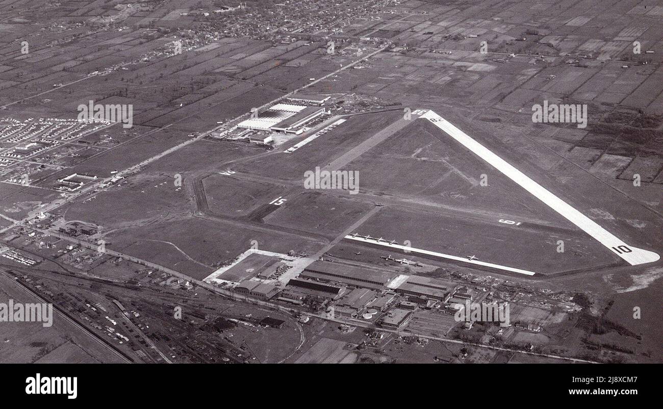 Cartierville airport in Saint-Laurent, Quebec. The Norvick wartime housing can be seen on the left, the Canadian Vickers factory in the center and the Saint-Laurent's city center in the background  ca.  1946 Stock Photo