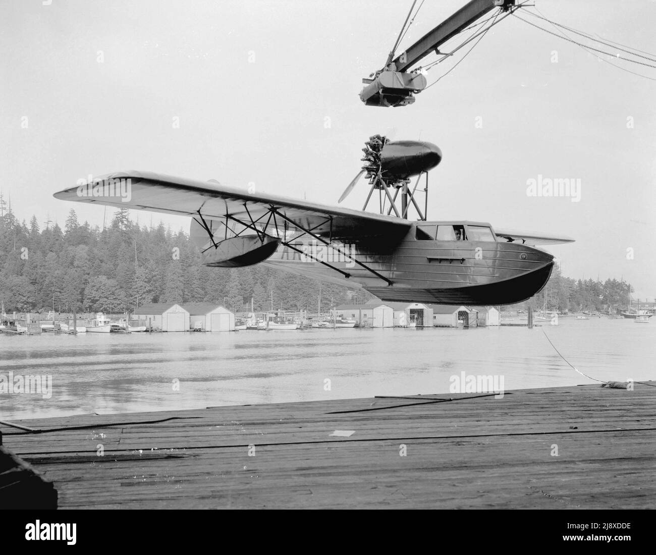 Boeing Aircraft Co. of Canada, Totem flying boat CF-ARF on hoist over wharf  ca.  1932 Stock Photo