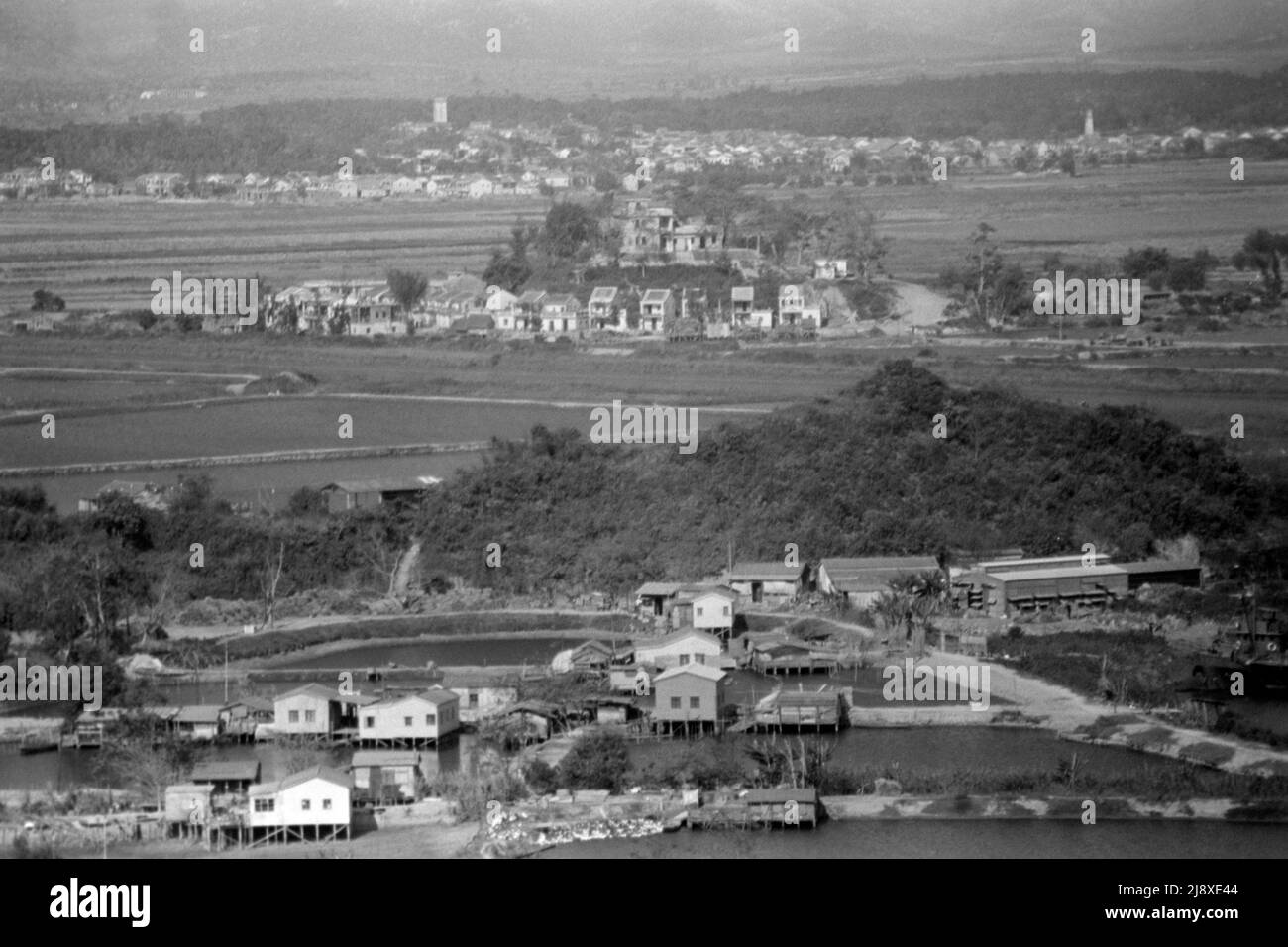 Black-and-white view of Ha Wan Village, from Lok Ma Chau Police Station, looking north with the Shenzhen River and Shenzhen, Guangdong, China, beyond. Date:  late 1979.  This is the site of the present Lok Ma Chau Border Crossing bridge (built 1989). Stock Photo