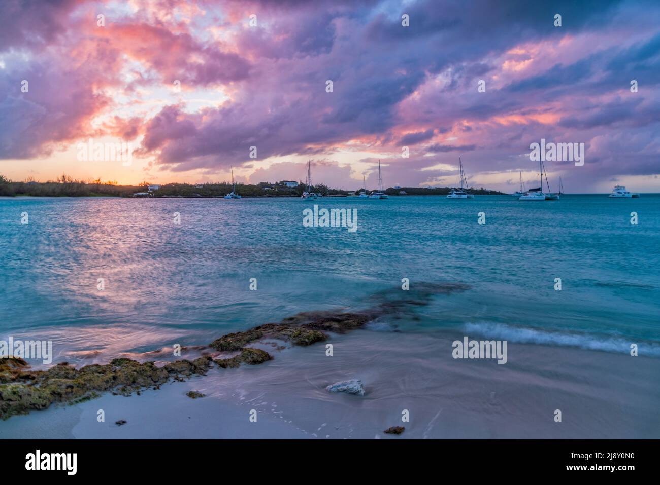 A quiet, colorful sunset on Jolly Hall Beach just north of George Town in Exuma, Bahamas Stock Photo