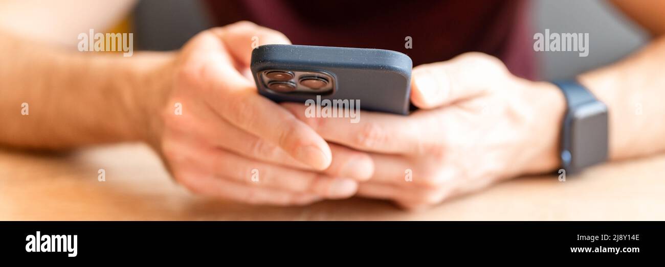 02.23.2022 Moscow. man using modern technology a mobile phone or smartphone iphone touching the digital screen. people texting message in social media Stock Photo