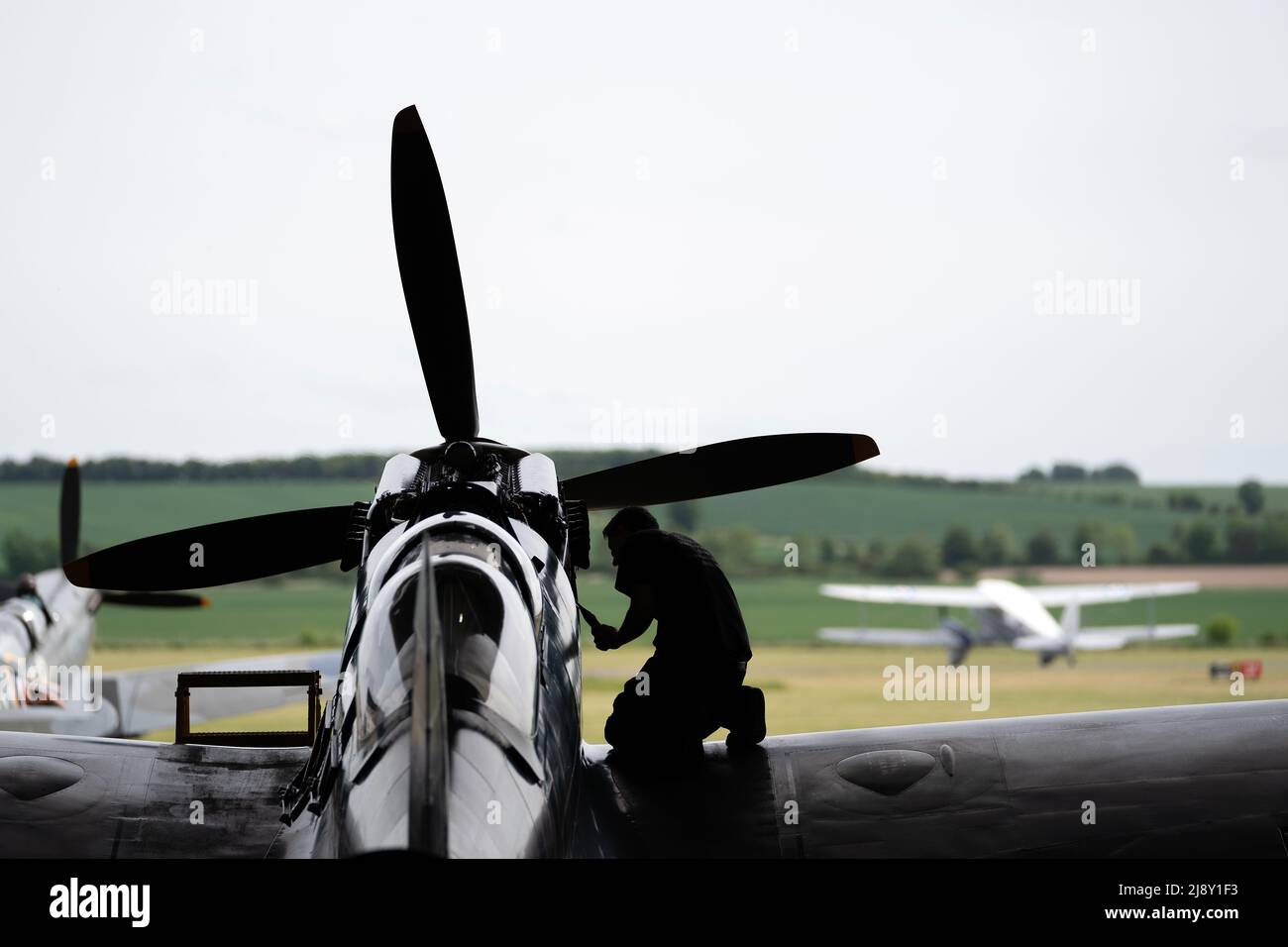 Aircraft Restoration Company engineers carry out maintenance on a Supermarine Spitfire at IWM Duxford in preparation for the Duxford Summer Air Show. Picture date: Wednesday May 18, 2022. Stock Photo