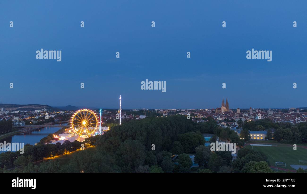 Aerial drone view of the fair Maidult in Regensburg, Bavaria, Germany with ferris wheel and beer tents at night Stock Photo