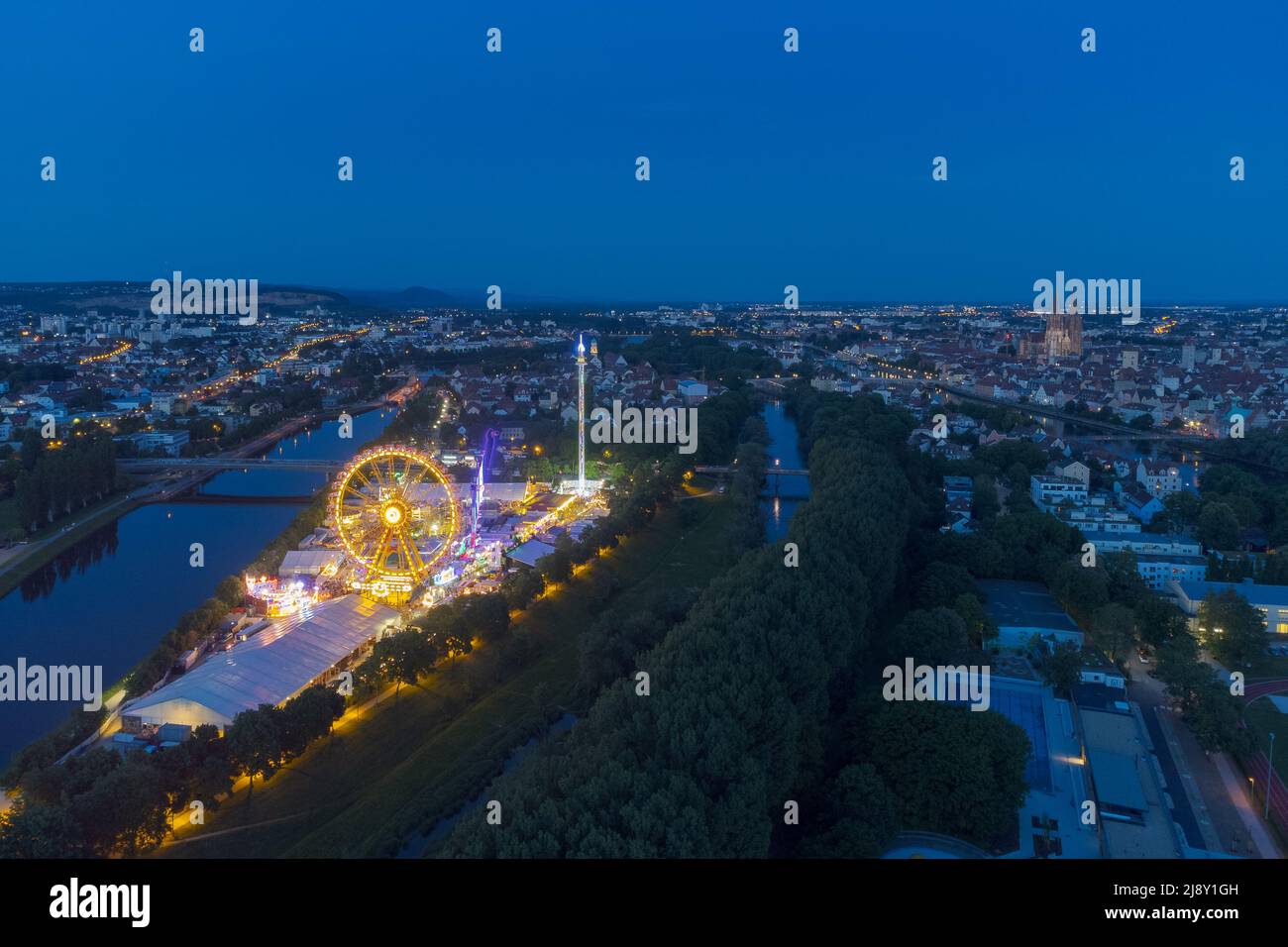 Aerial drone view of the fair Maidult in Regensburg, Bavaria, Germany with ferris wheel and beer tents at night Stock Photo