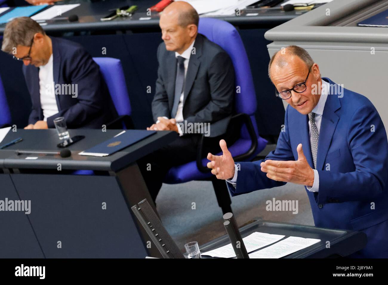 Leader of Germany's Christian Democratic Union (CDU) Friedrich Merz speaks while German Chancellor Olaf Scholz and German Economy and Climate Minister Robert Habeck listen during a session of Germany's lower house of parliament, the Bundestag, in Berlin, Germany, May 19, 2022. REUTERS/Hannibal Hanschke Stock Photo