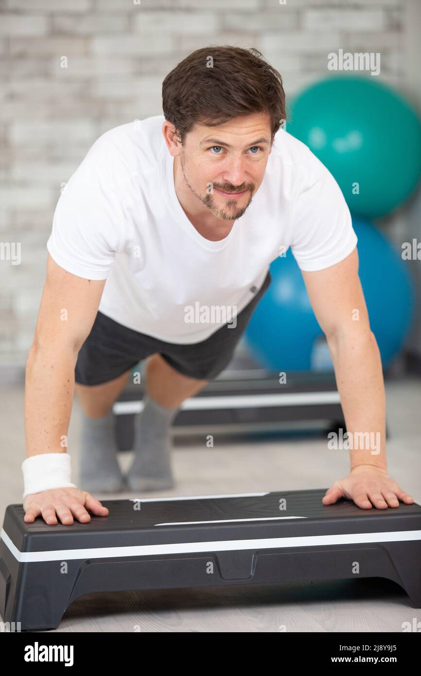 sporty male doing pushups on a step platform Stock Photo Alamy