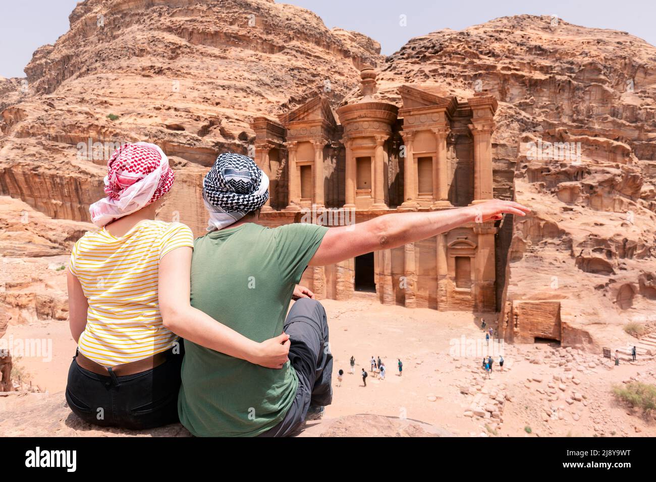 A young couple is watching the monastery of petra - Jordan - travel Stock Photo