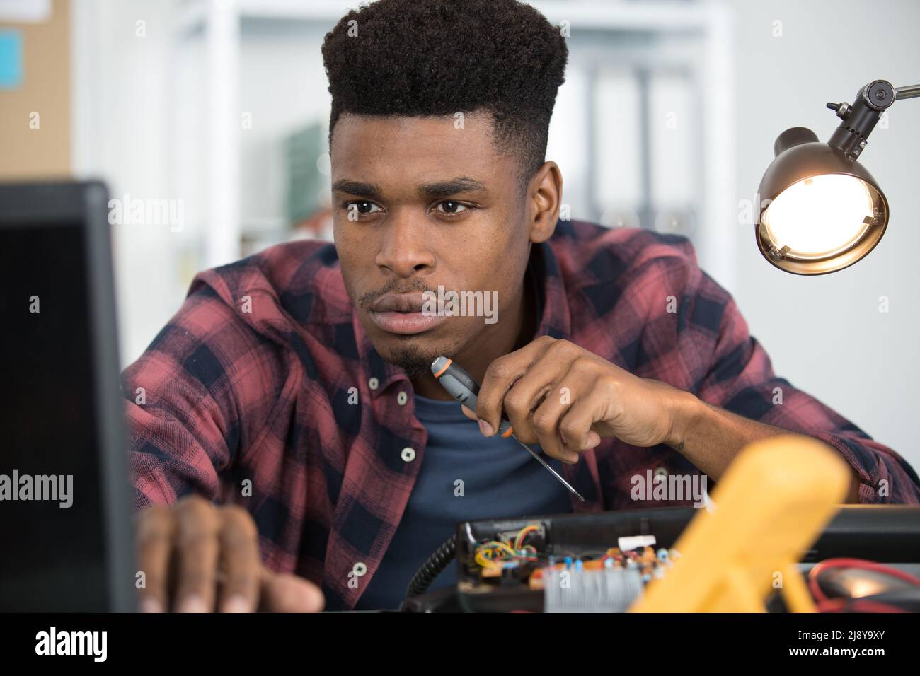 portrait of man fixing pc Stock Photo